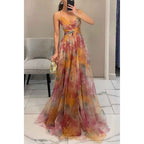 Amara – Elegant maxi dress made of floral chiffon, with delicate spaghetti straps and a sophisticated cut-out