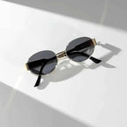 Elina – Oval women's sunglasses with metal frame and dark lenses